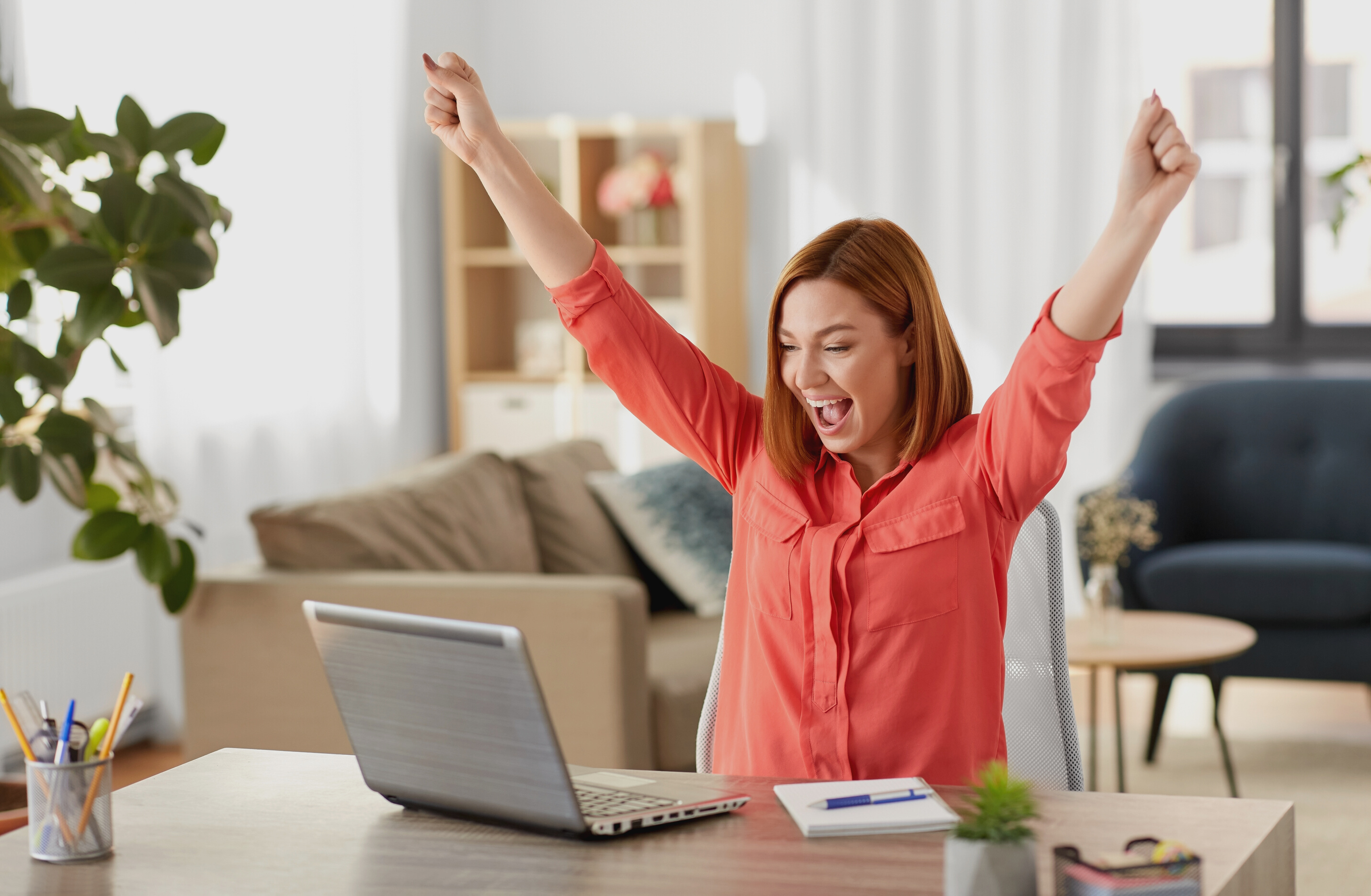 Happy Woman with Laptop Working at Home Office